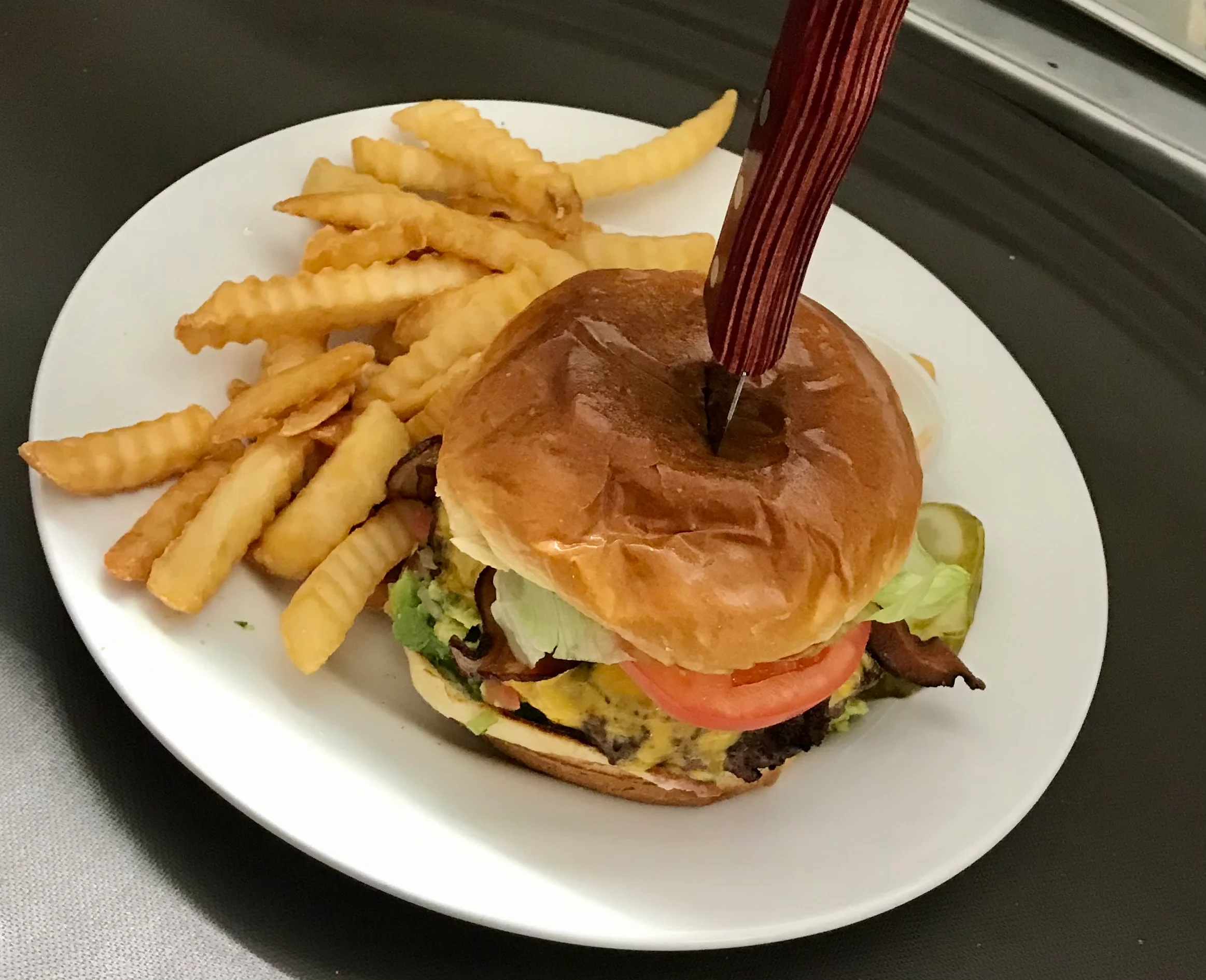 Juicy cheeseburger with fries served in a casual dining setting