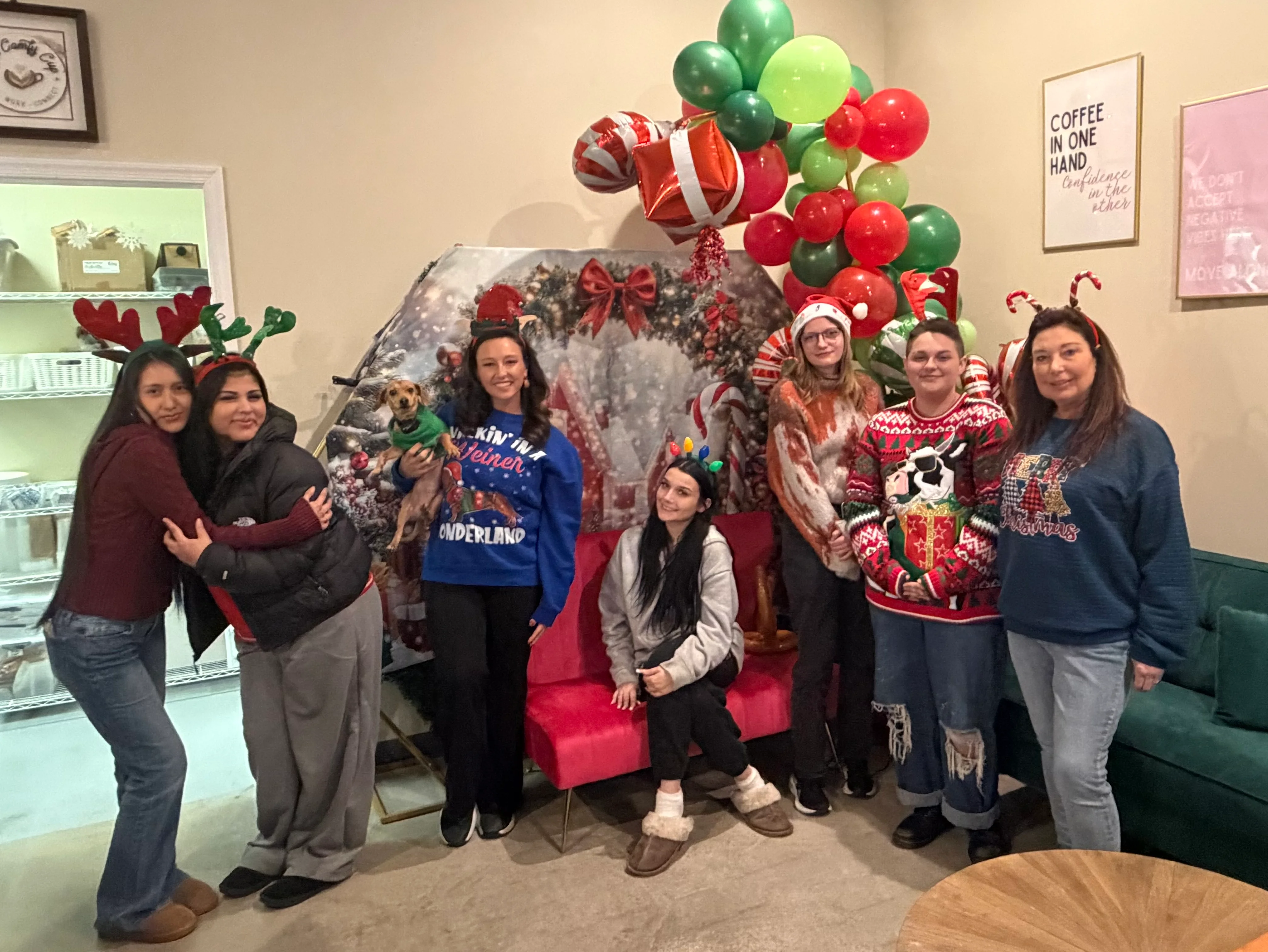 Festive group photo with holiday decorations and themed attire