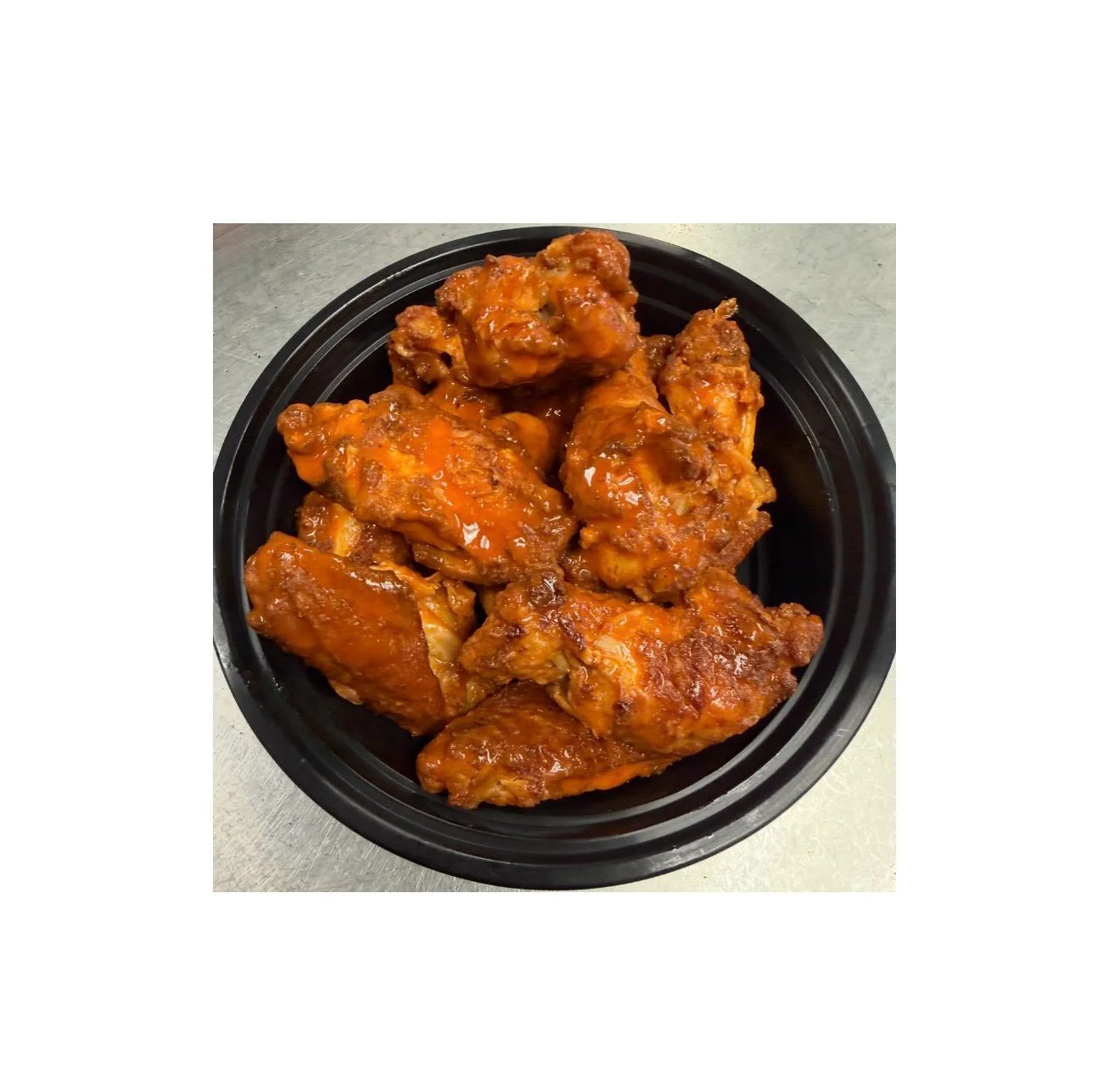 Crispy buffalo chicken wings on a silver platter