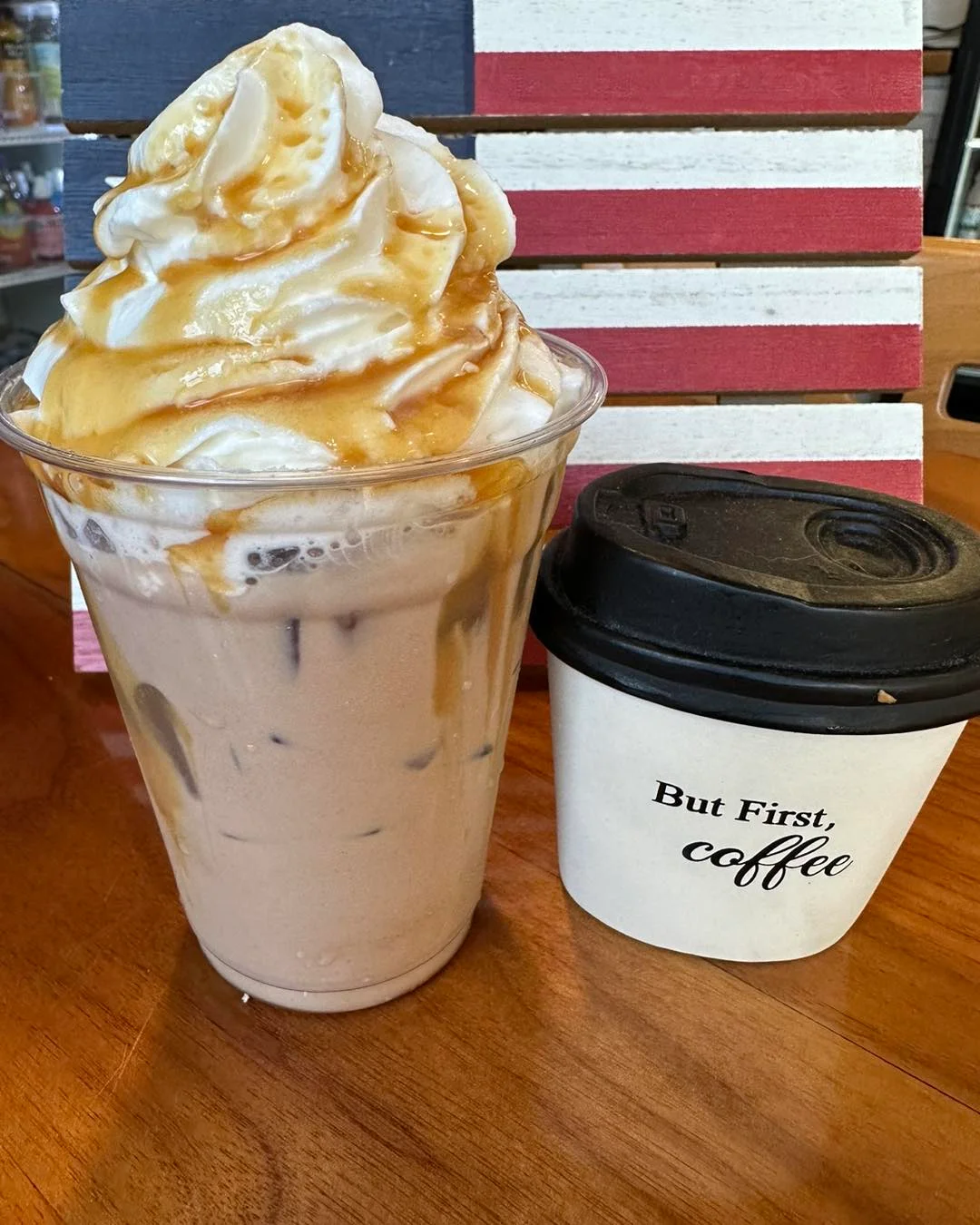 A beautifully crafted latte with intricate foam art in a white cup.