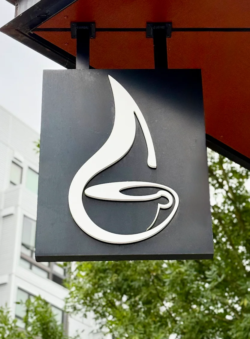 Stylish restaurant sign featuring a coffee cup design