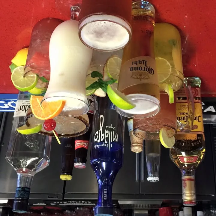 Colorful cocktails and beers at a vibrant bar counter
