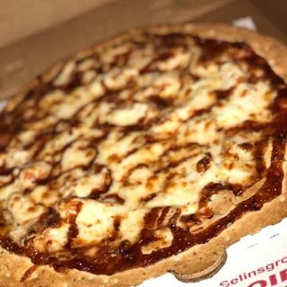 Delicious pepperoni pizza on a wooden pizza peel
