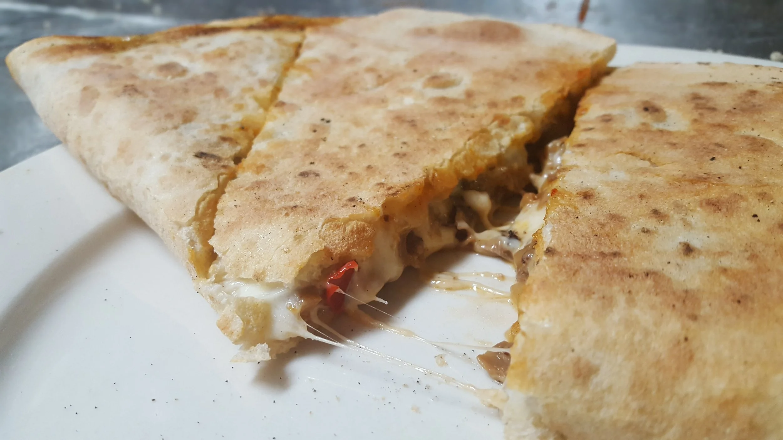Cheesy quesadilla with melted cheese and peppers