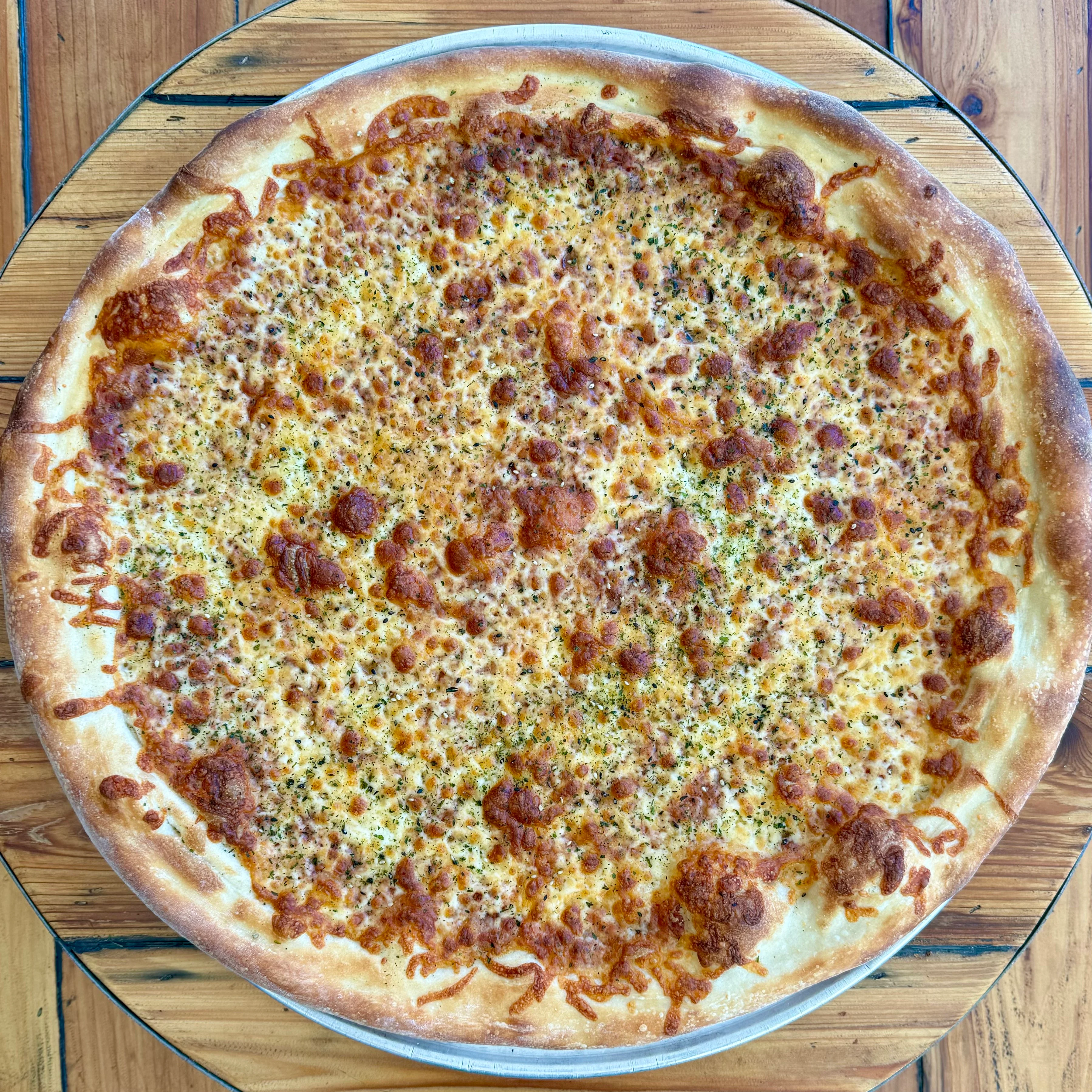 Cheese pizza with golden crust and herbs
