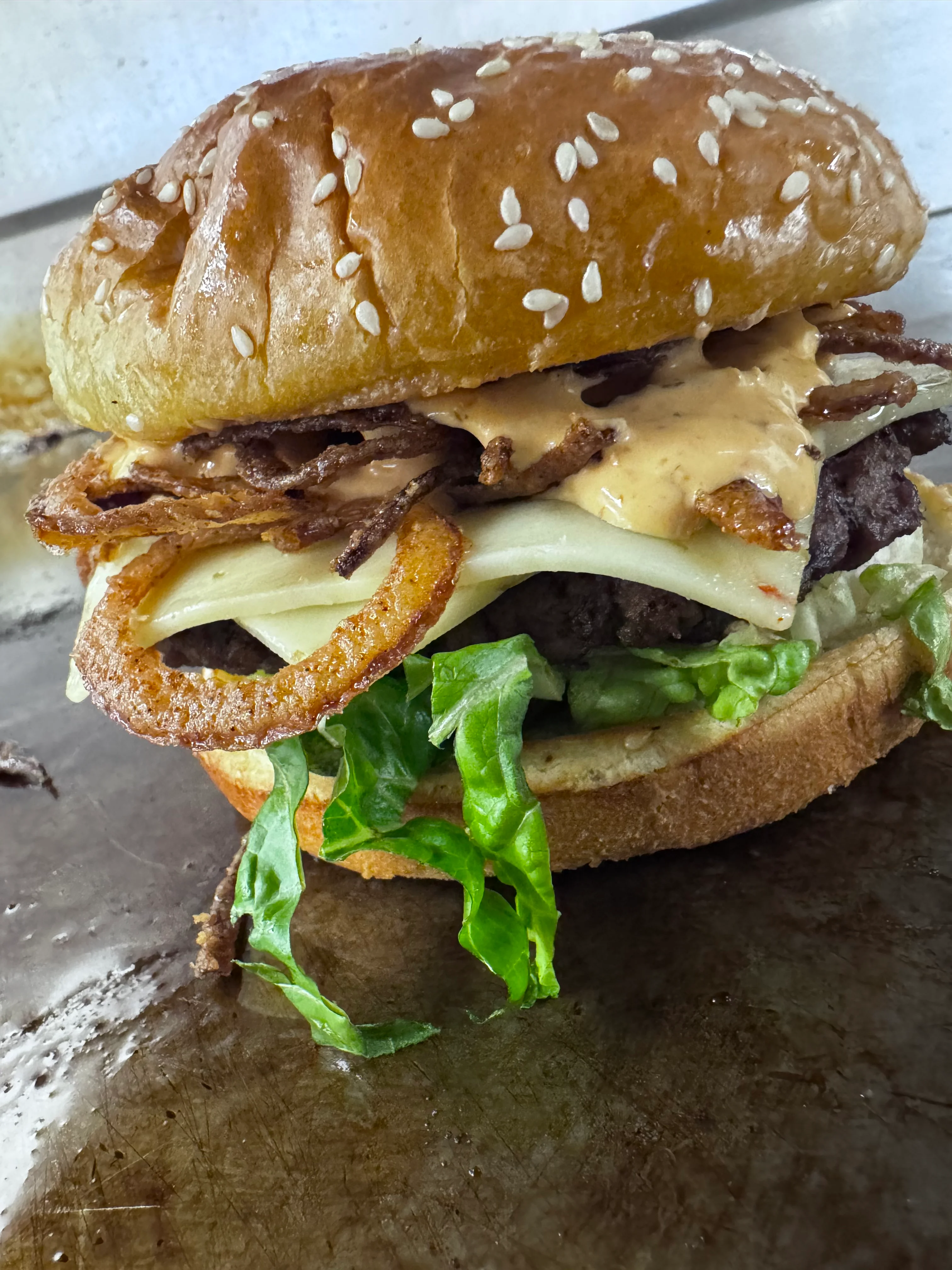 Juicy cheeseburger with crispy onions and lettuce