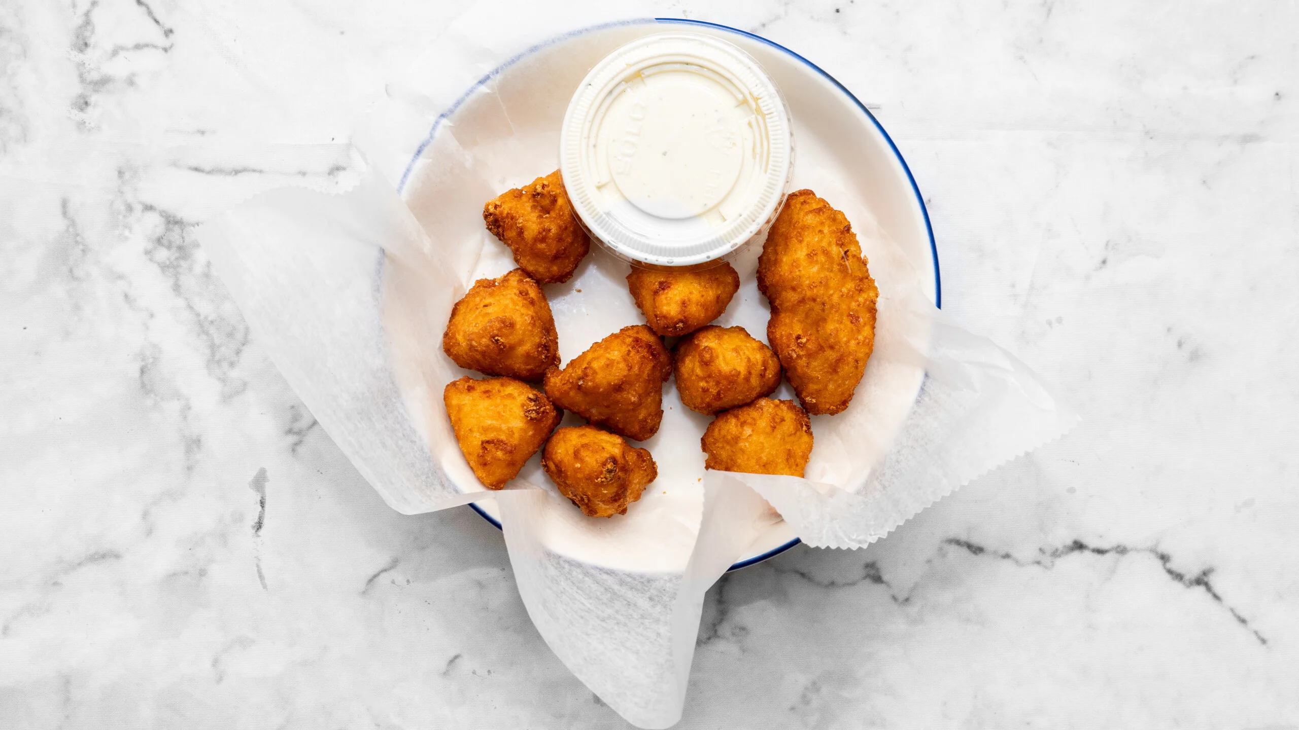 Crispy Southern hush puppies served with dipping sauce