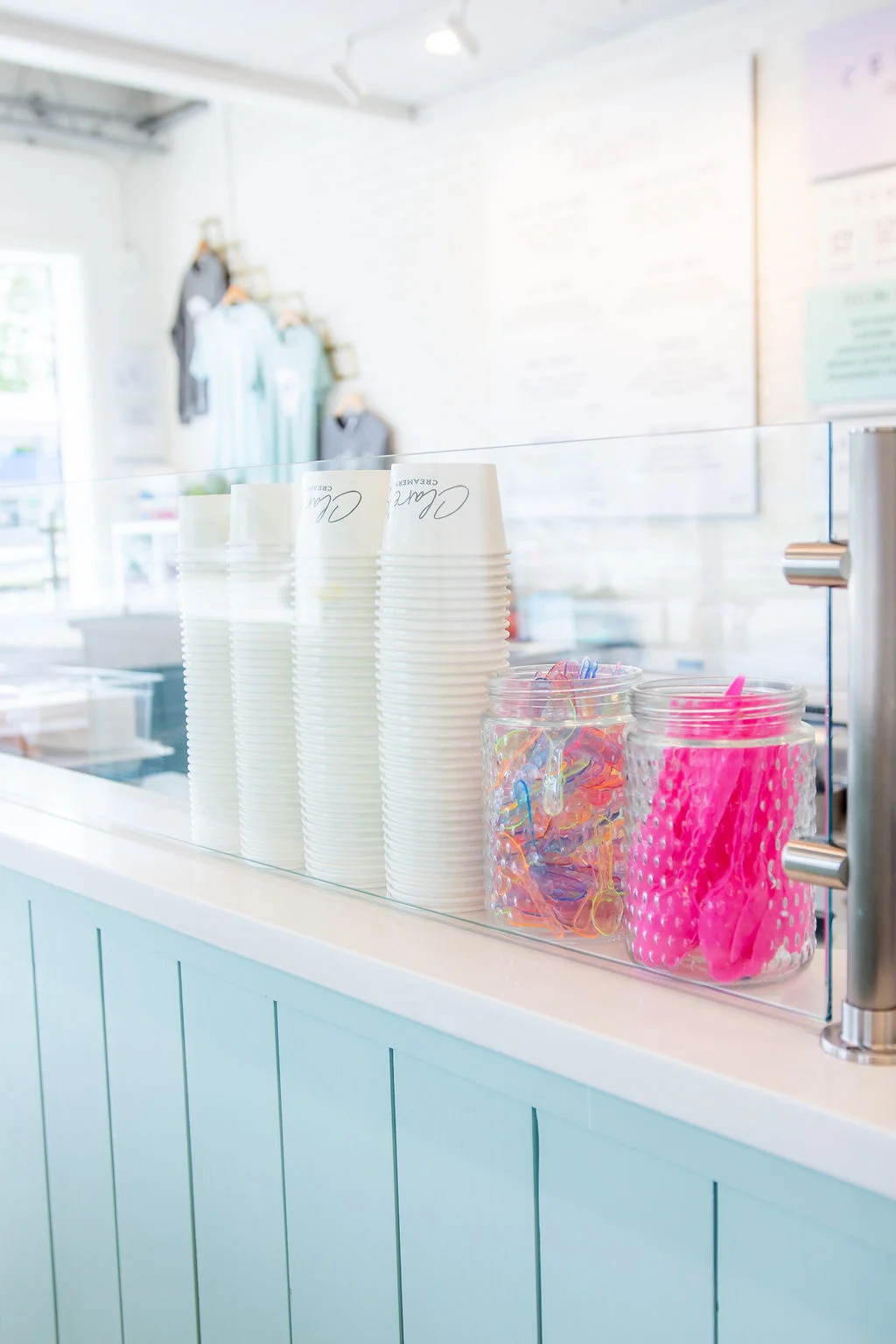 Modern restaurant counter with cups and colorful utensils