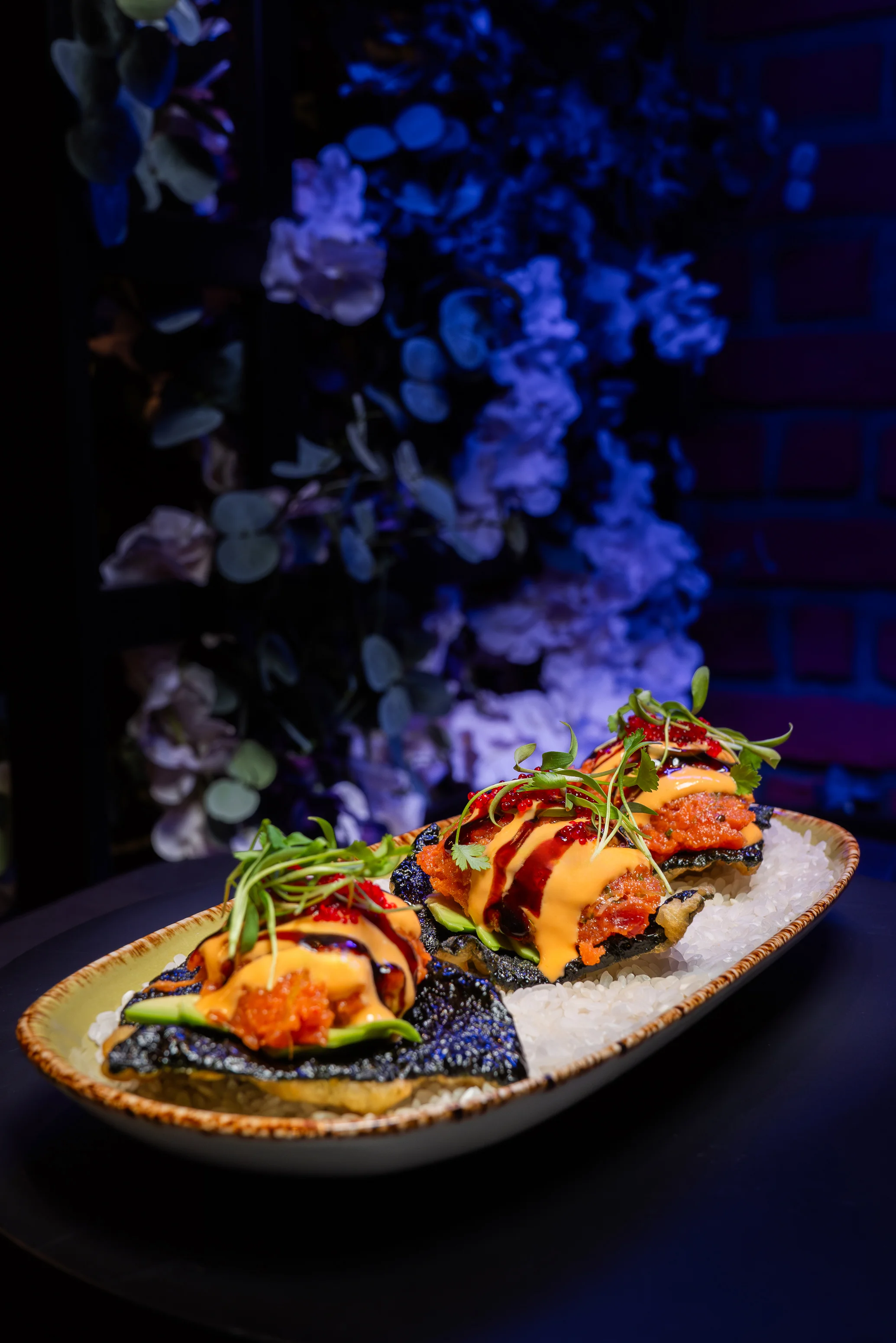 Japanese sushi rolls with spicy toppings and garnishes