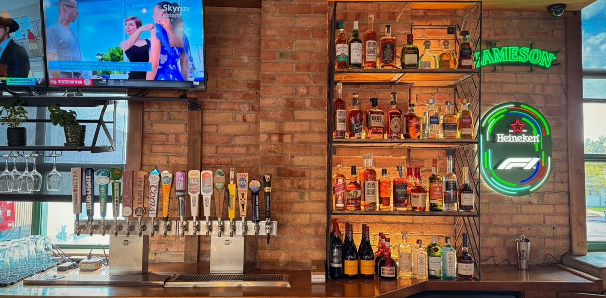 Modern bar interior with a variety of spirits and draft beers