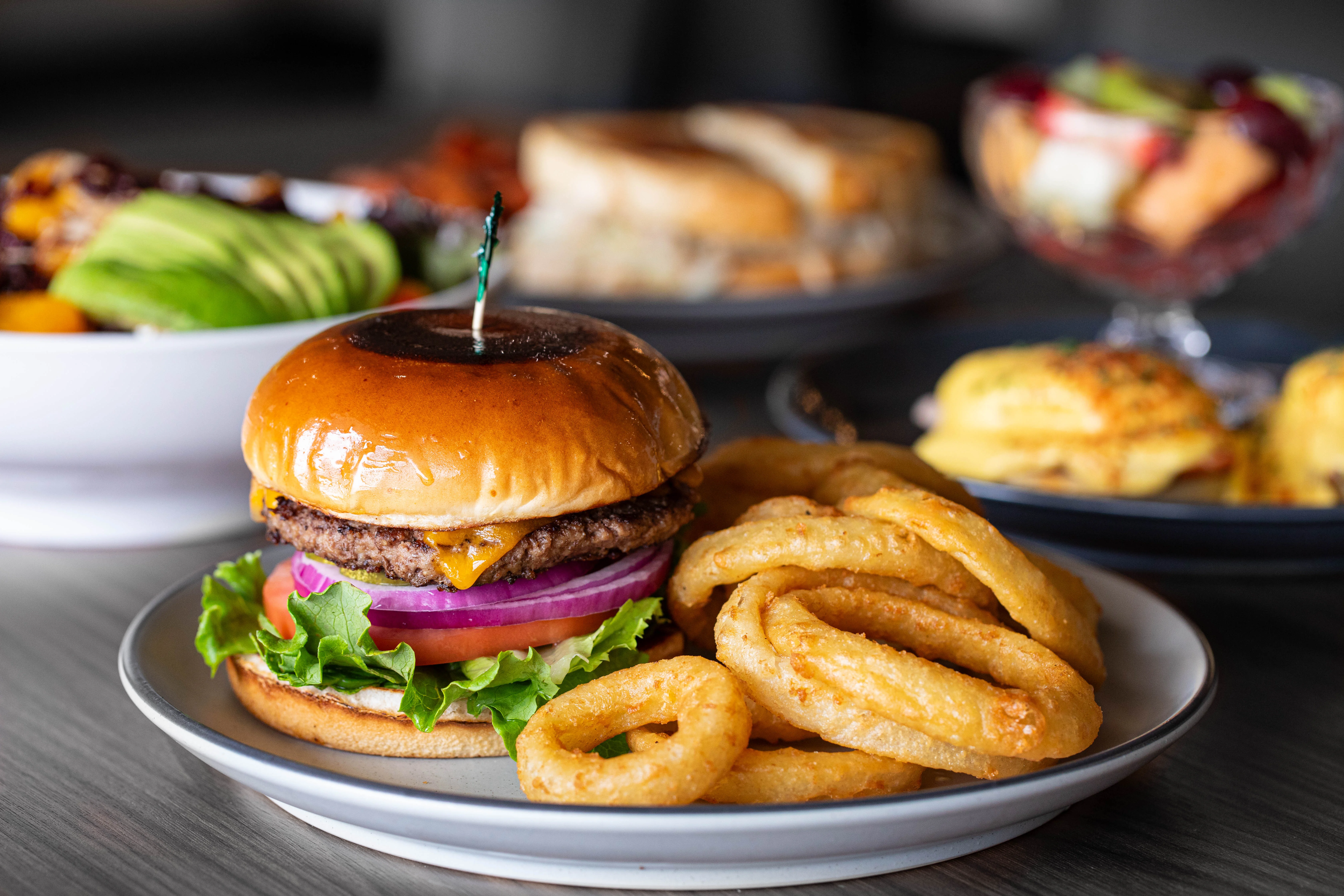 A burger with a side of onion rings