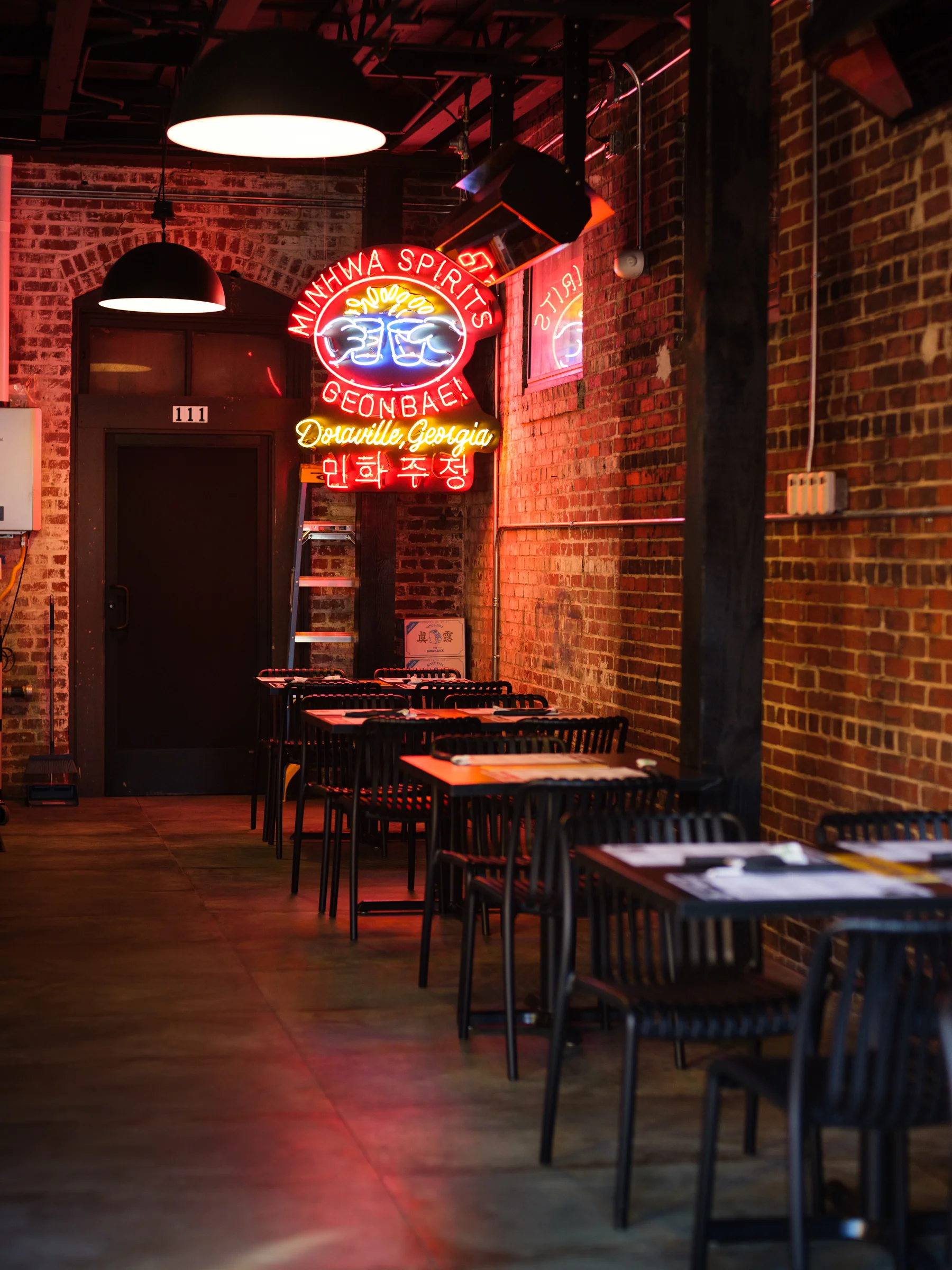 Cozy restaurant interior with neon signage and exposed brick walls