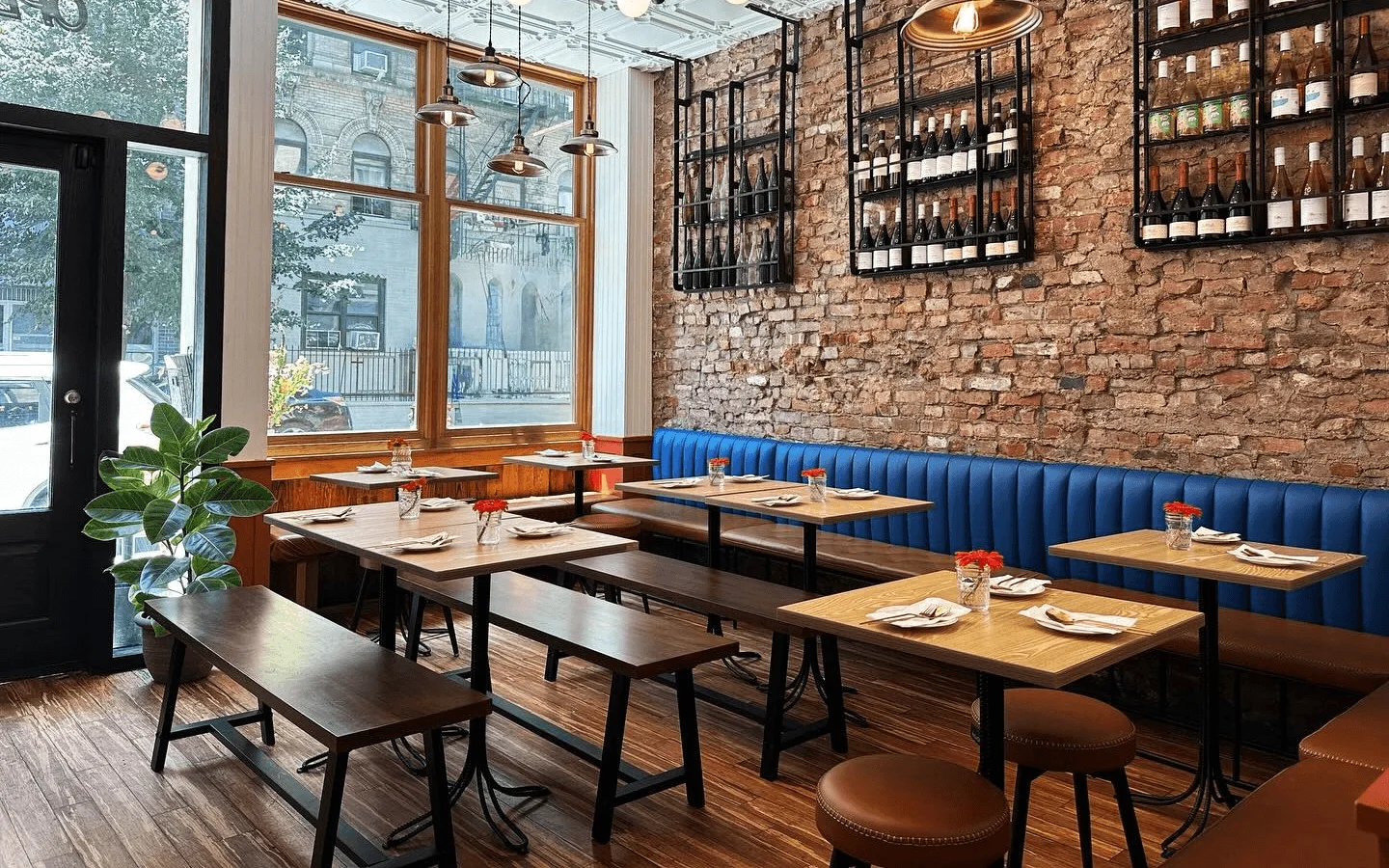 Cozy restaurant interior with exposed brick and blue seating