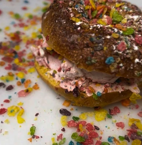Colorful cereal bagel sandwich with cream filling