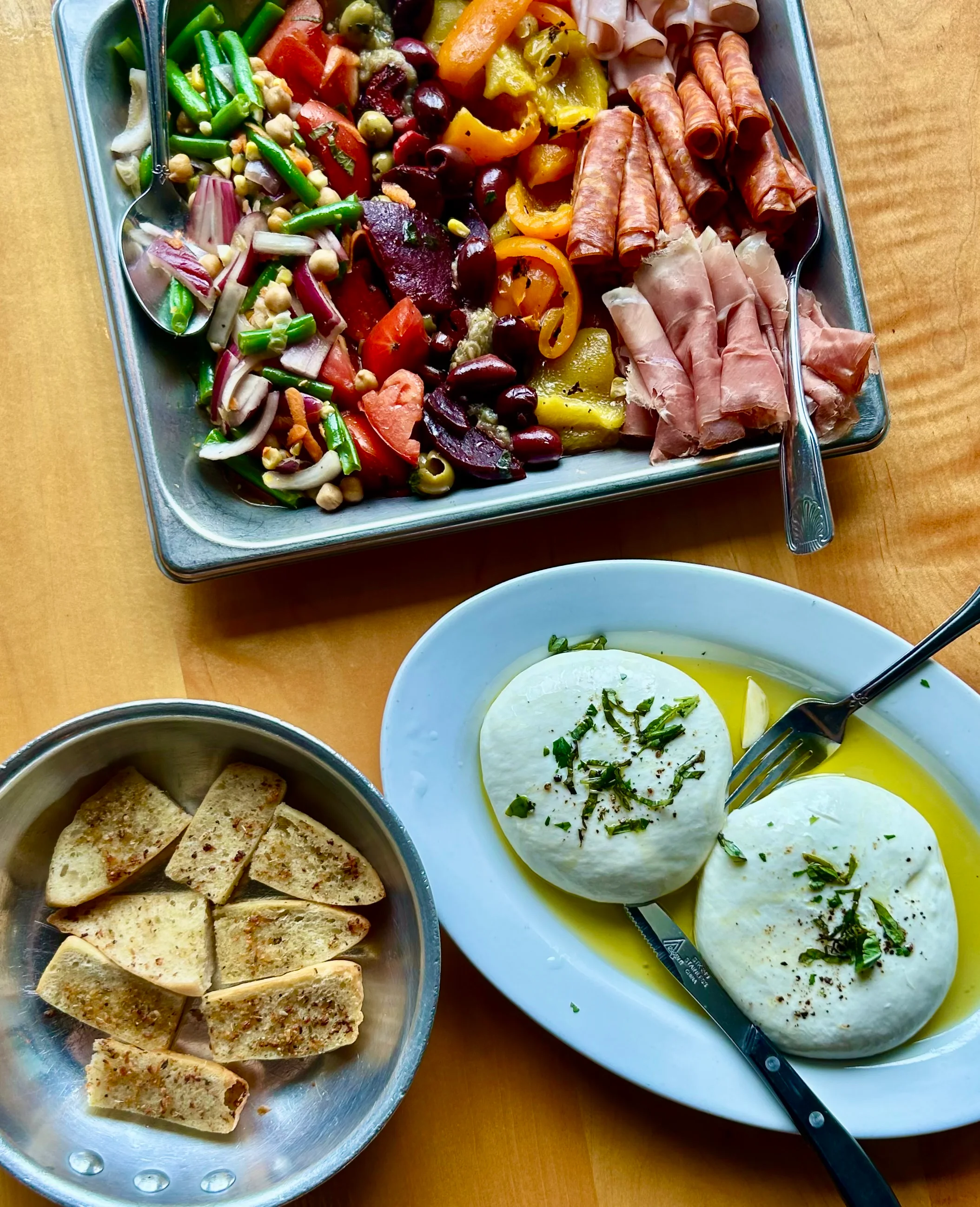 Mediterranean antipasto platter with fresh mozzarella and grilled bread
