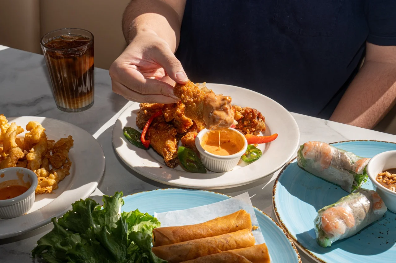 Crispy Vietnamese chicken wings with dipping sauce and fresh spring rolls