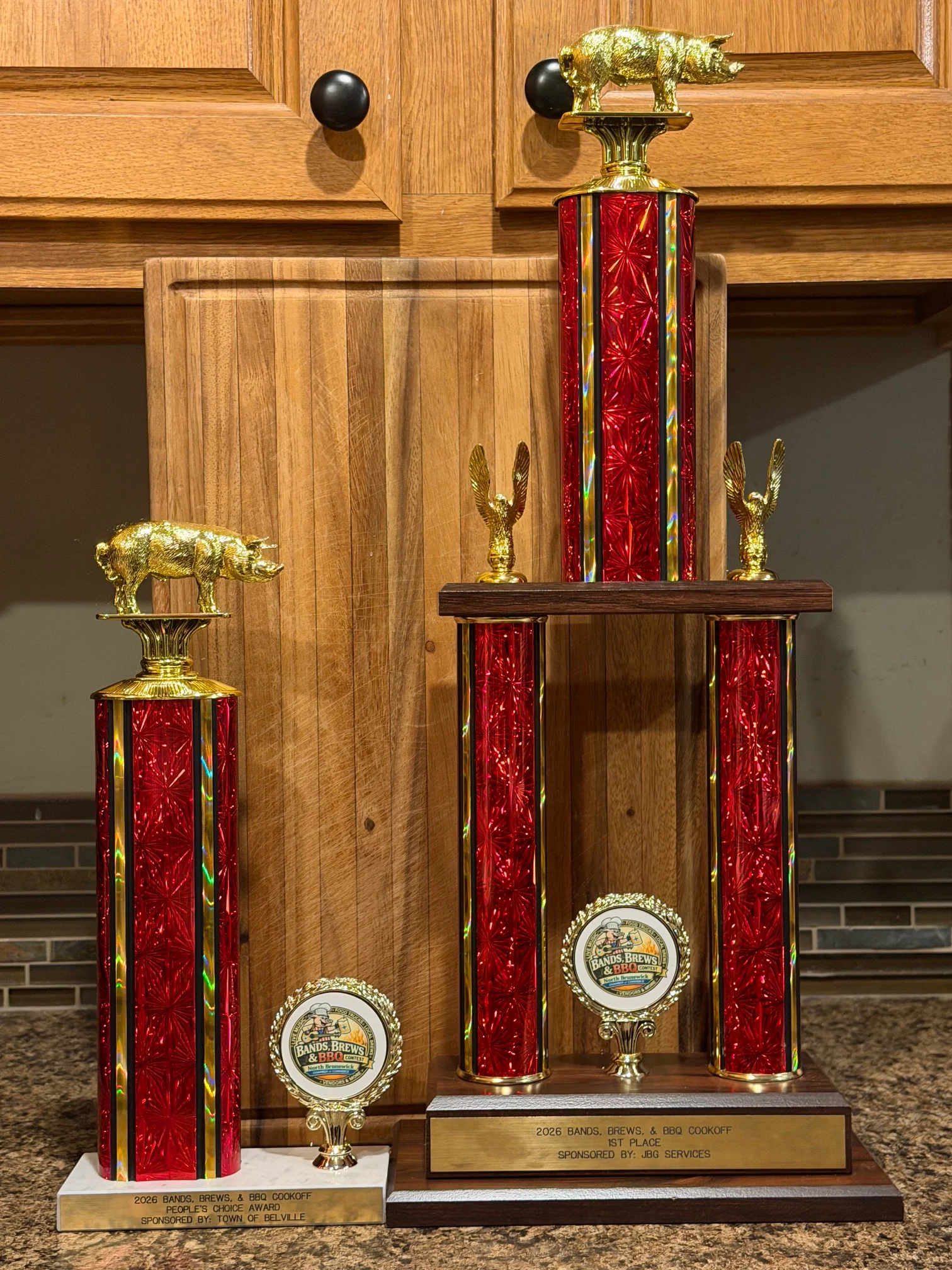 Trophies from a BBQ cookoff competition with decorative elements