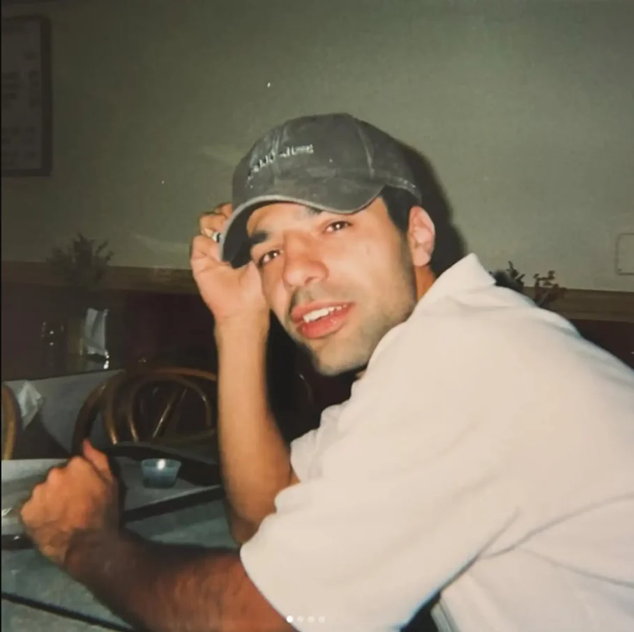 Casual dining scene with a man in a cap at a restaurant table