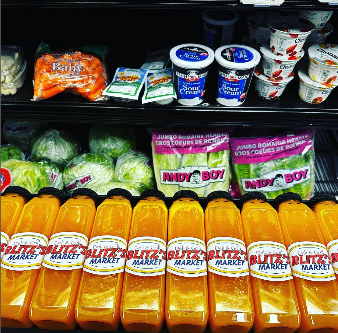 Grocery display with fresh produce and juice bottles