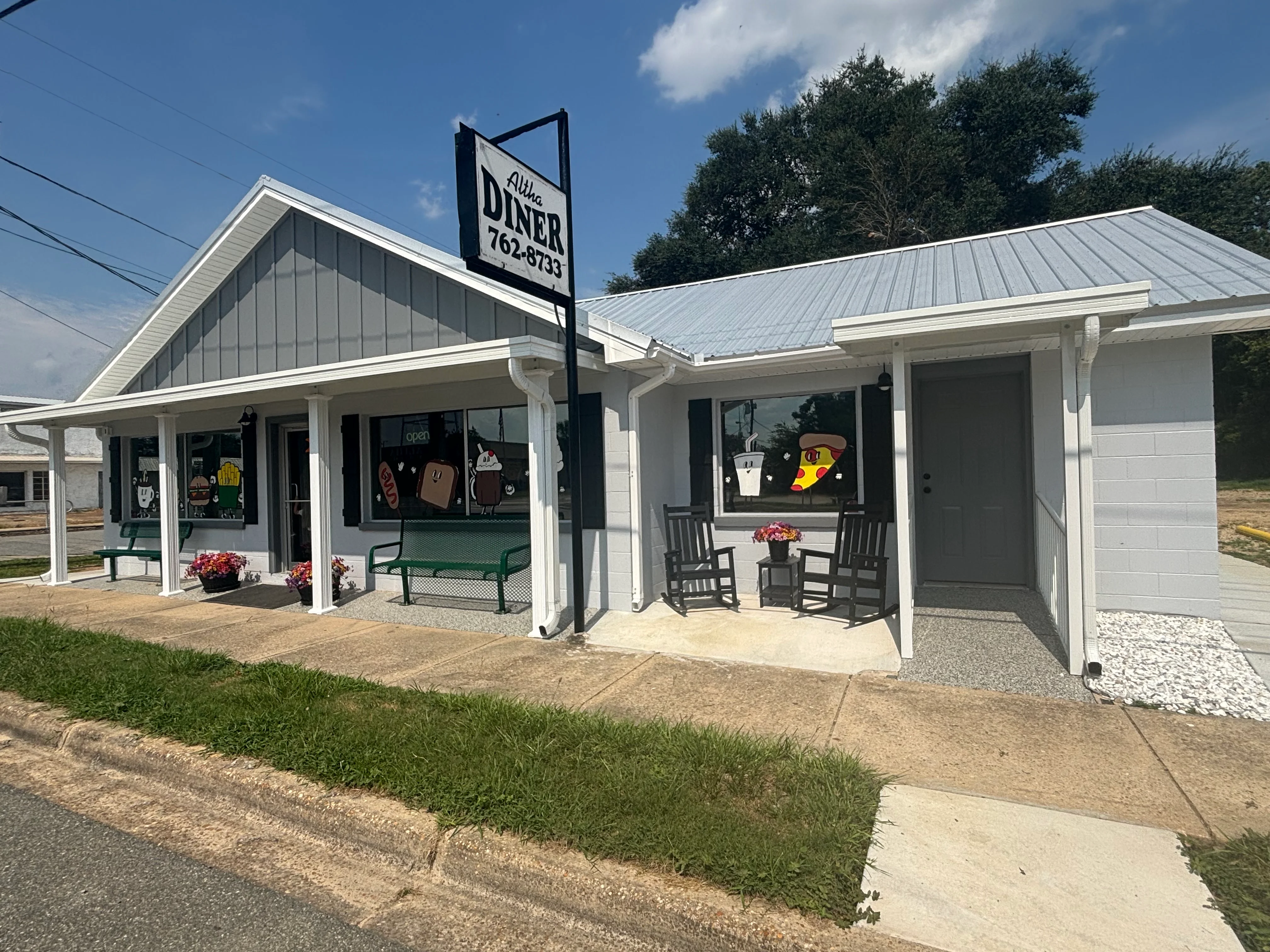 Charming diner exterior with colorful signage and seating area