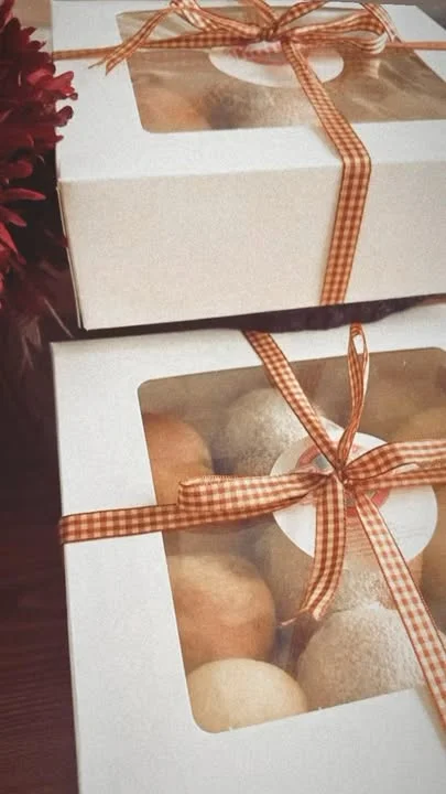 Gift boxes of assorted pastries with decorative ribbons