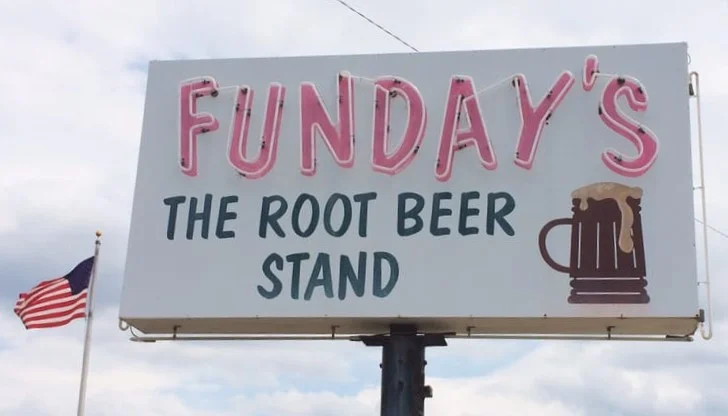 Sign for Funday's Root Beer Stand with a frothy mug illustration