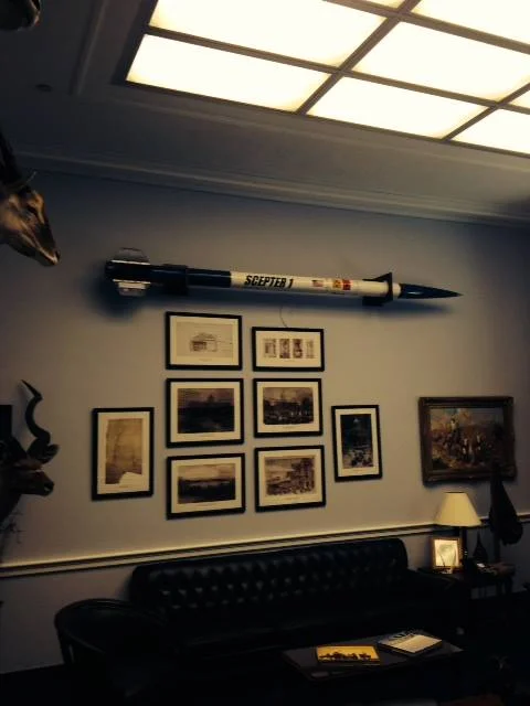 Office interior featuring a decorative rocket and framed artwork