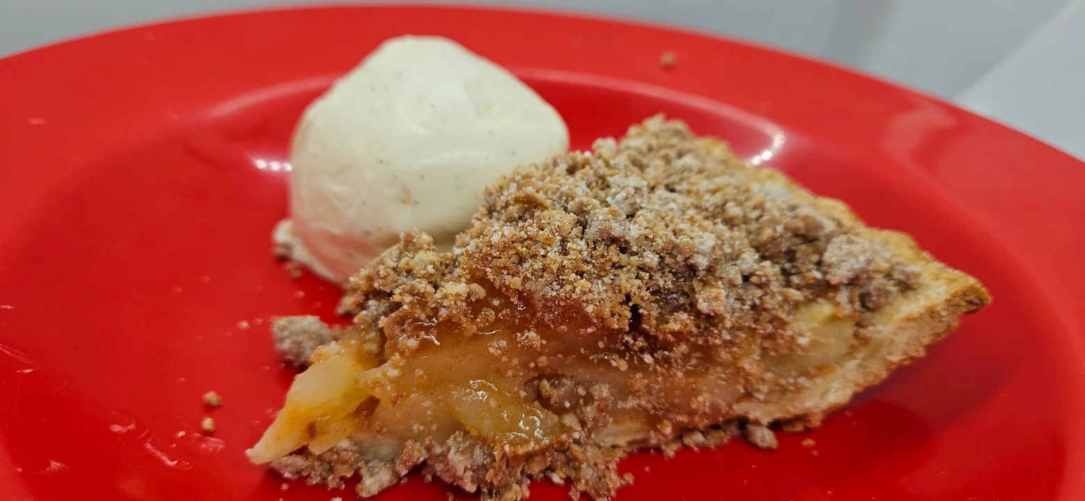 Warm apple pie a la mode with vanilla ice cream served at VooDoo BBQ Pensacola.