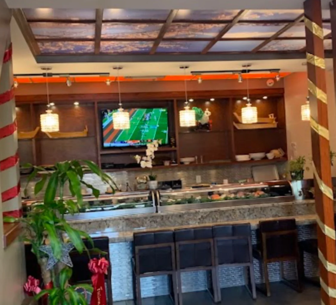 Cozy restaurant interior with sushi bar and warm lighting