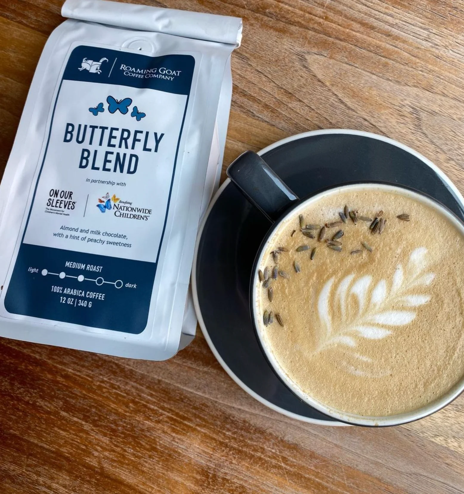 Cup of latte art with lavender on a wooden table