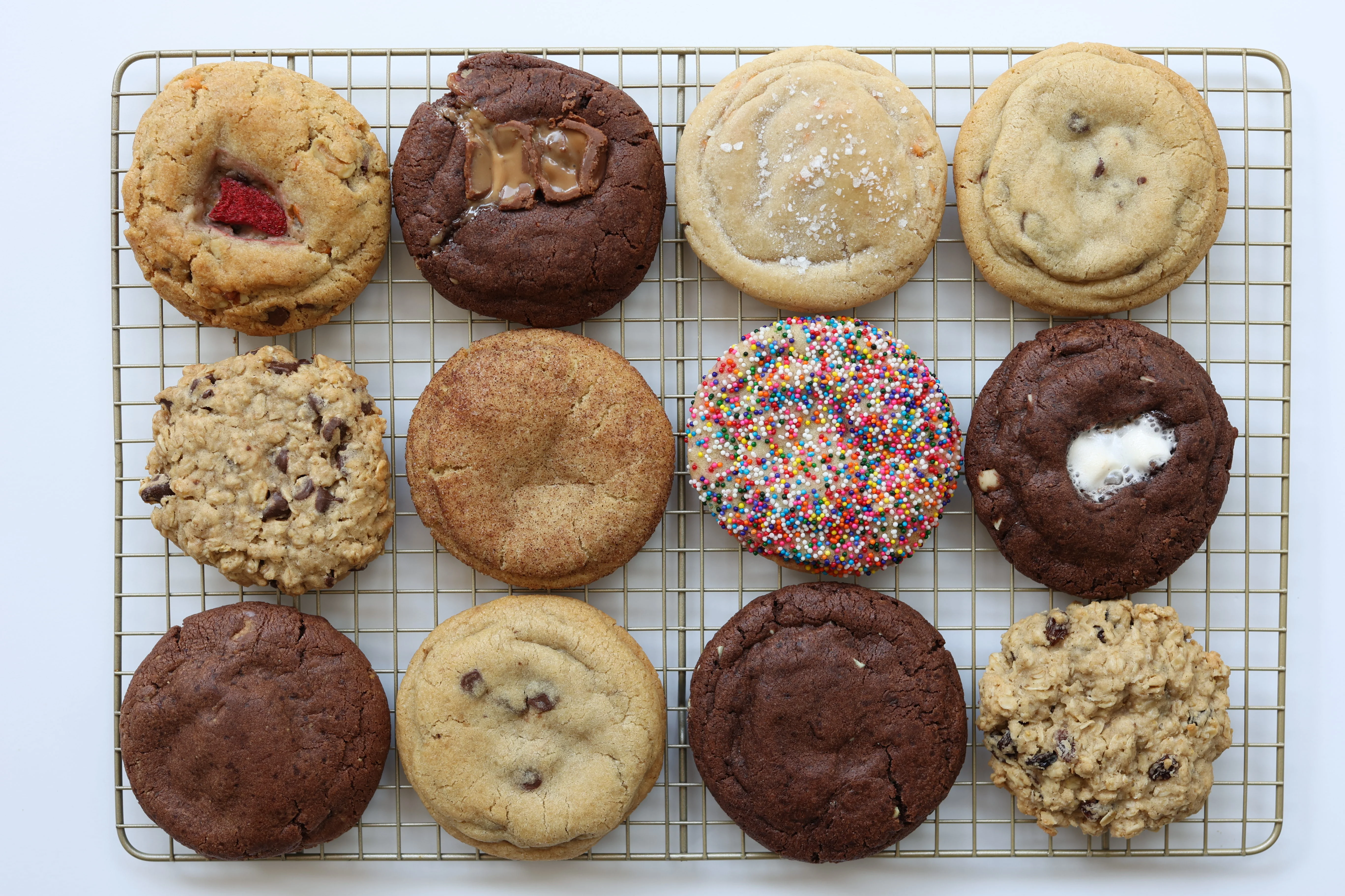 Assorted gourmet cookies on a cooling rack