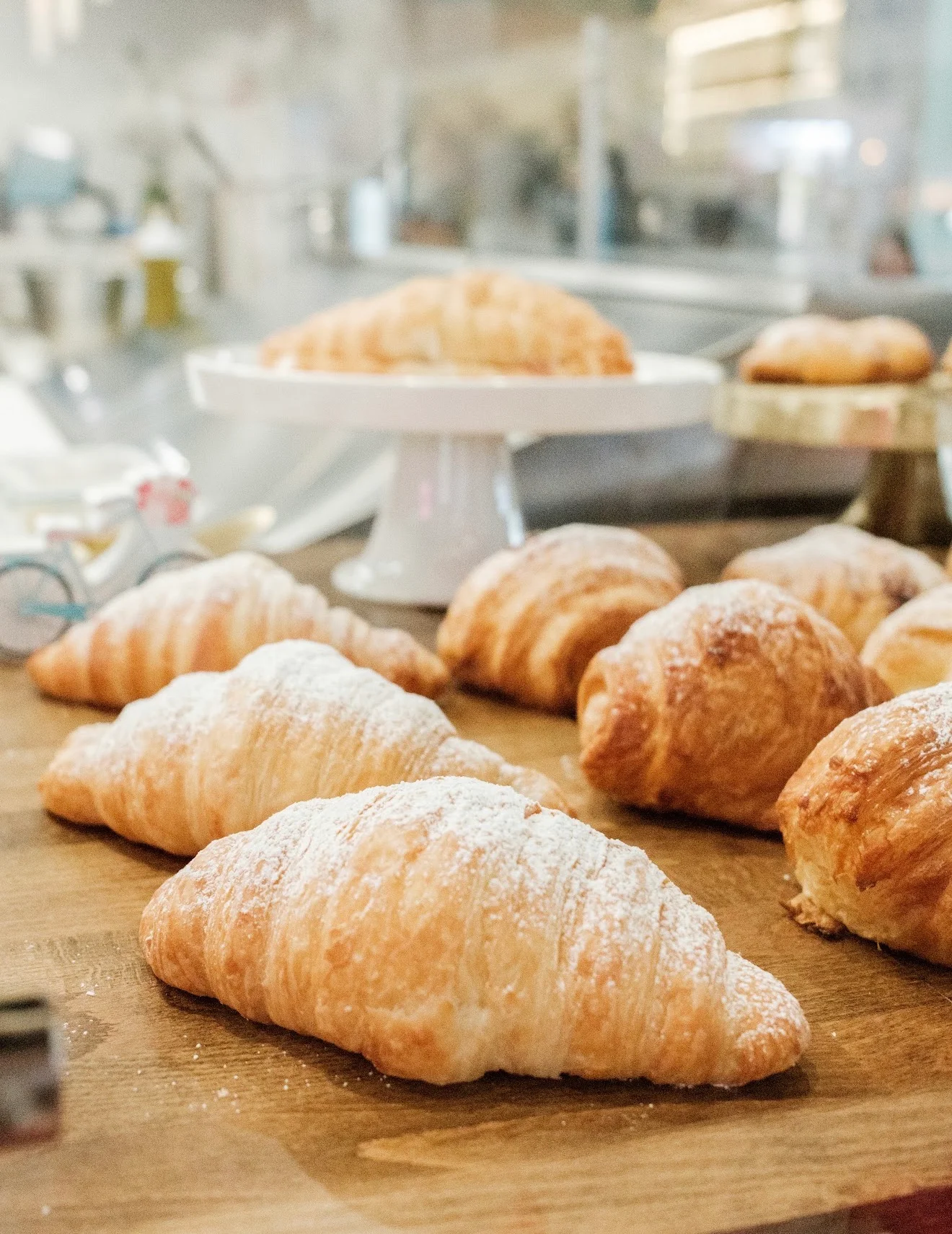 Freshly baked French croissants dusted with powdered sugar
