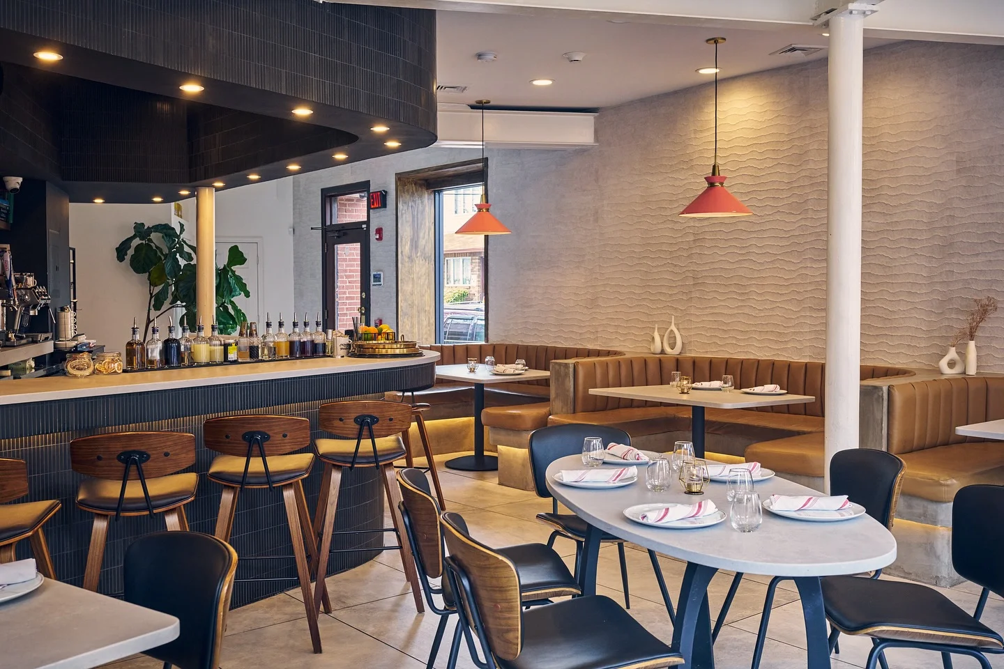 Modern restaurant interior with stylish seating and bar area