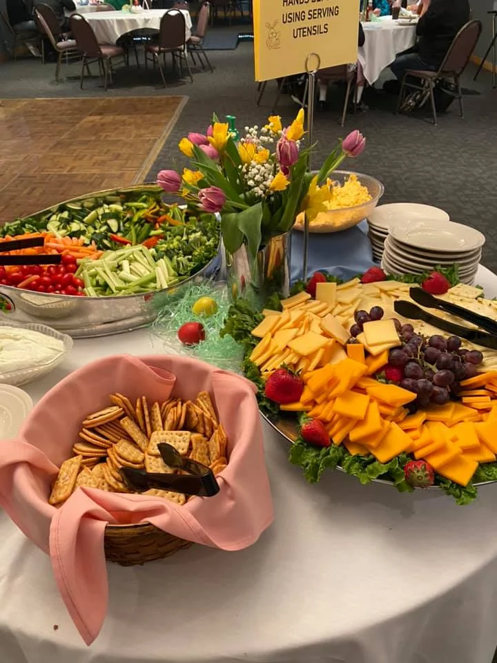 Colorful vegetable and cheese platter at a buffet table