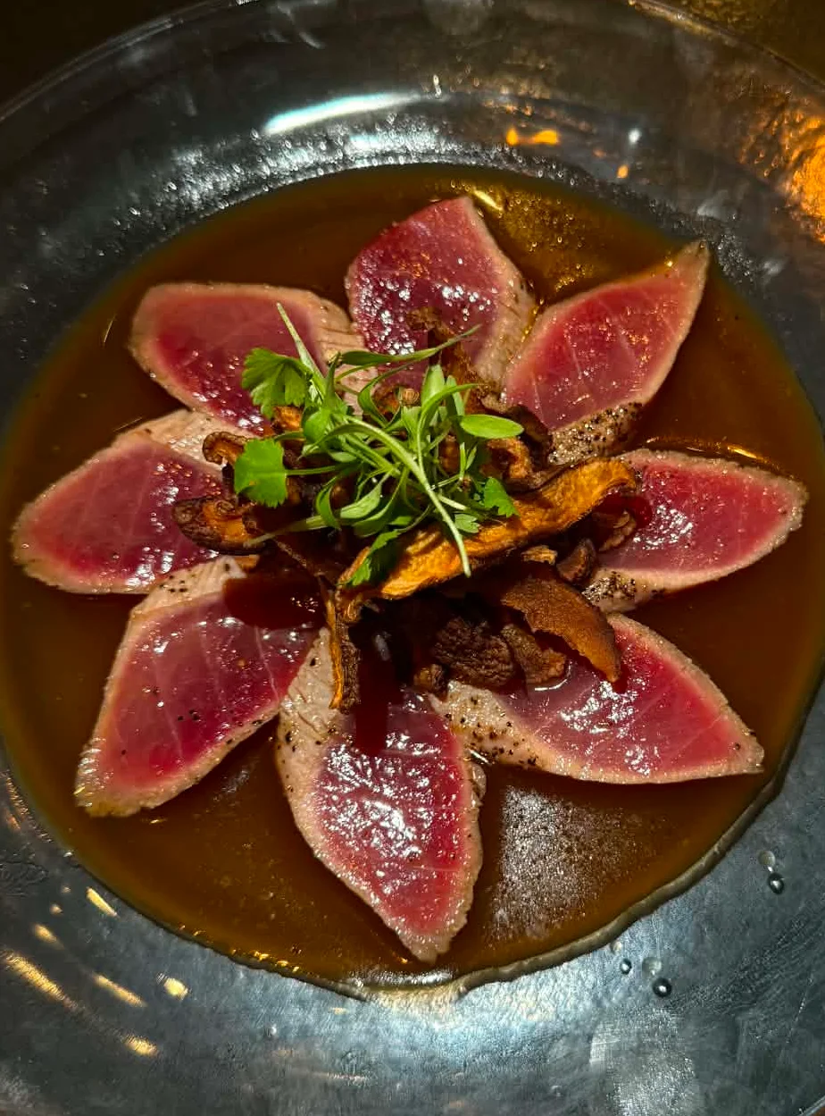 Japanese tataki-style seared tuna with soy sauce and microgreens