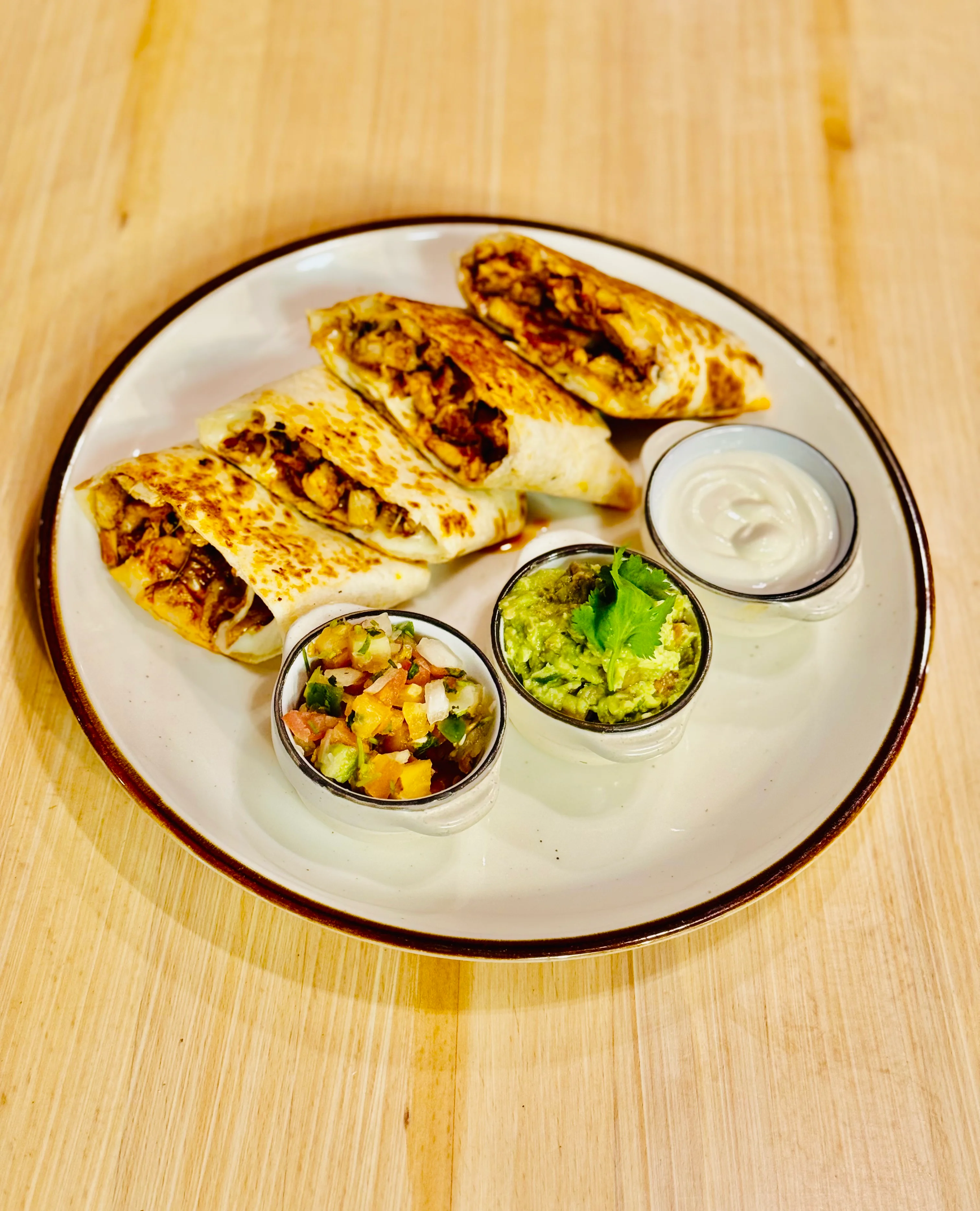Delicious chicken burritos with guacamole and salsa