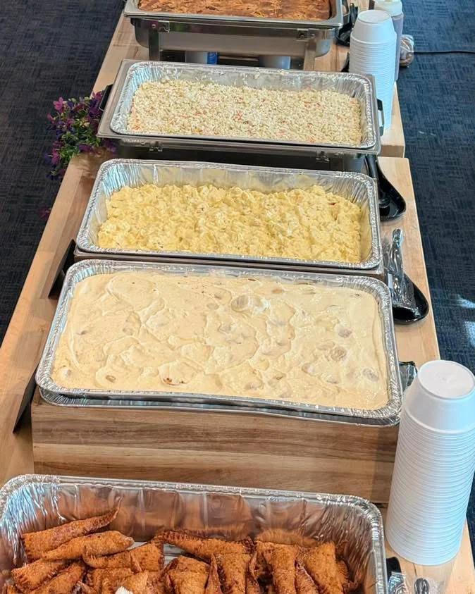 Catered buffet with creamy casseroles and fried appetizers in serving trays