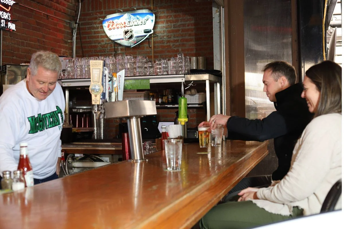 Bartender serving happy customers draft beers