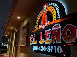Illuminated restaurant sign for El Leno with vibrant colors