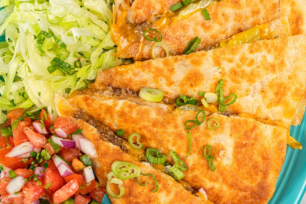 Crispy quesadillas served with lettuce and pico de gallo