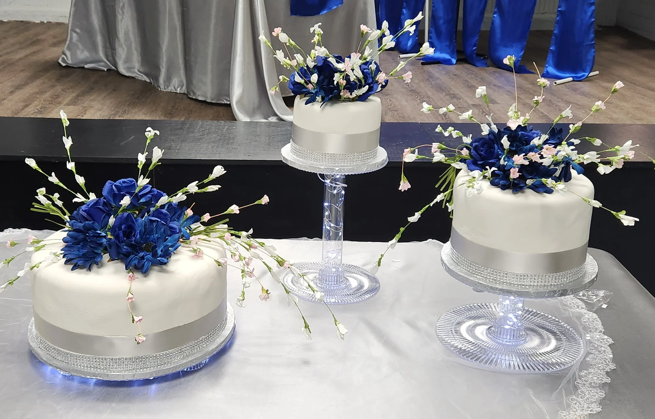 Elegant wedding cakes adorned with blue flowers and delicate accents