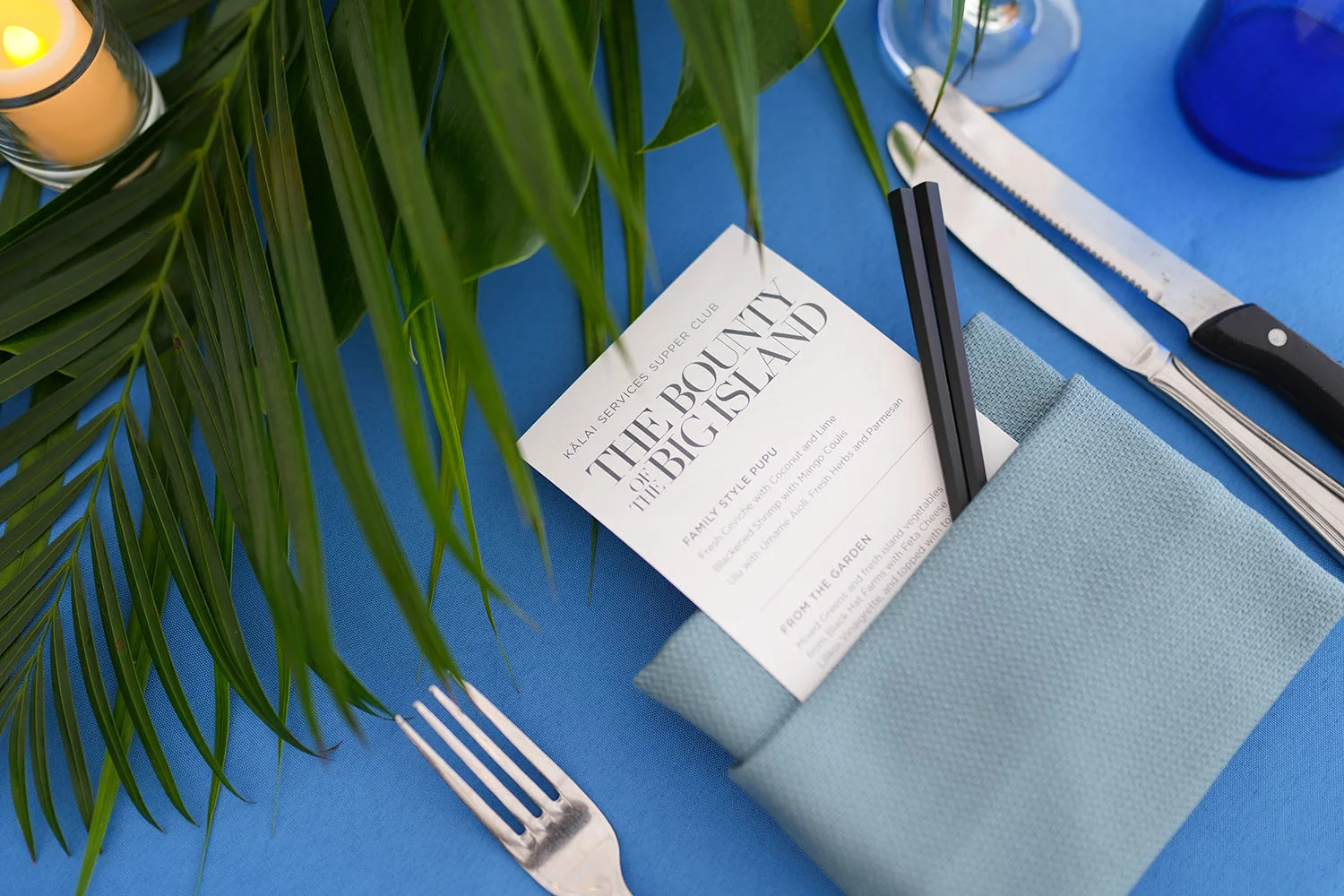 Elegant dining setup with menu and tropical decor