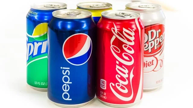 Assorted soda cans including Pepsi and Coca-Cola