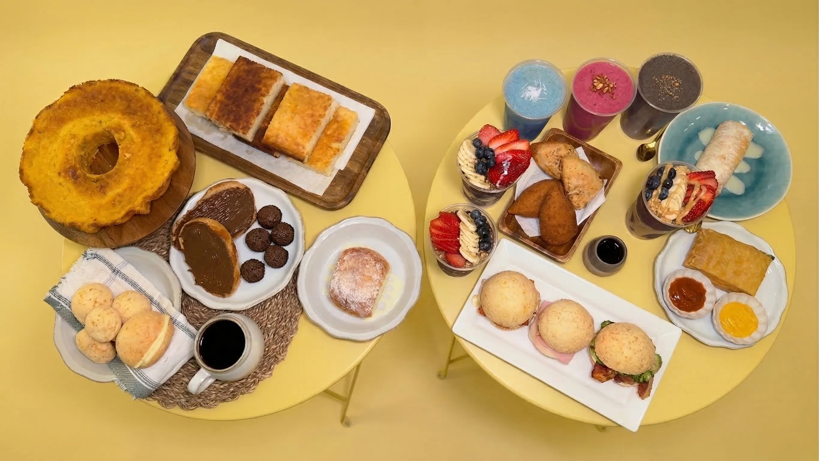 Assorted Latin American breakfast pastries and desserts on yellow tables