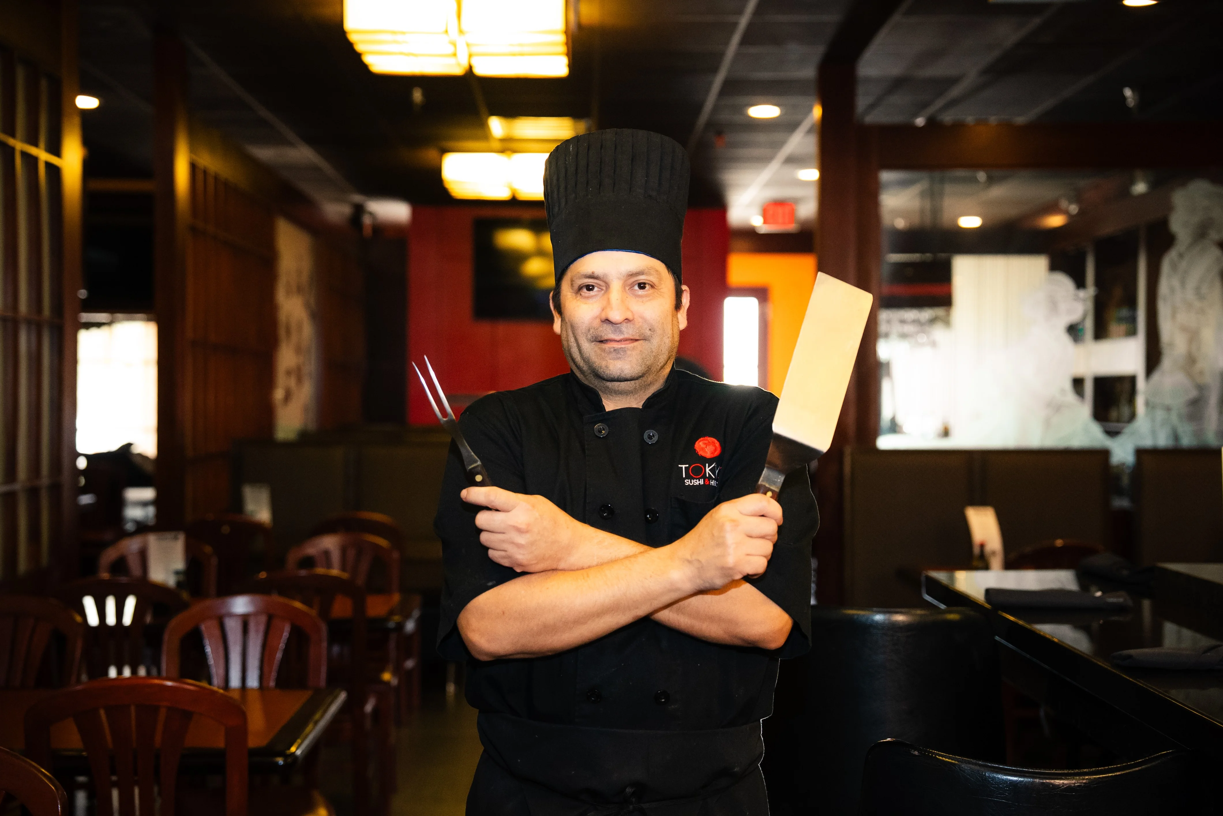 Chef in a Japanese restaurant with cooking tools