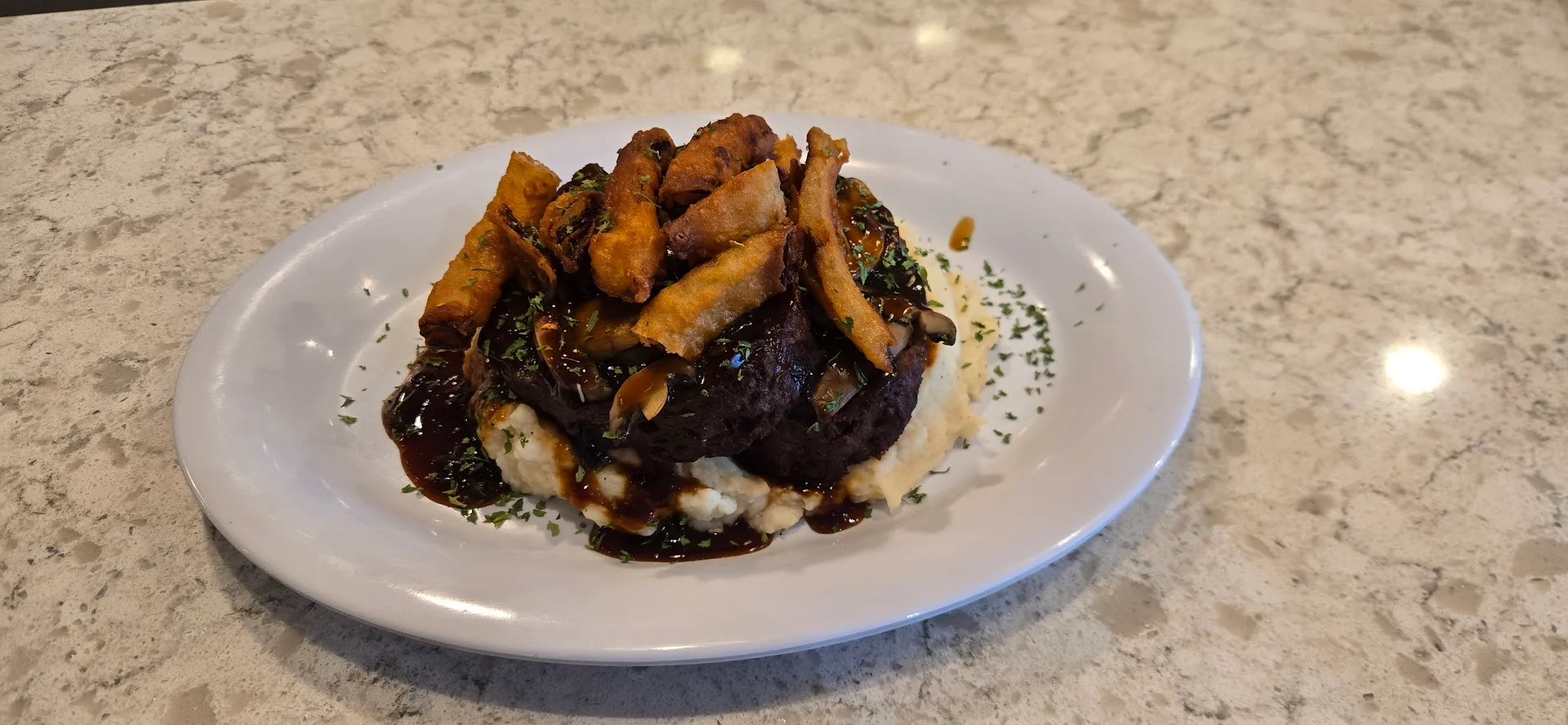 Savory Brazilian feijoada served with mashed potatoes
