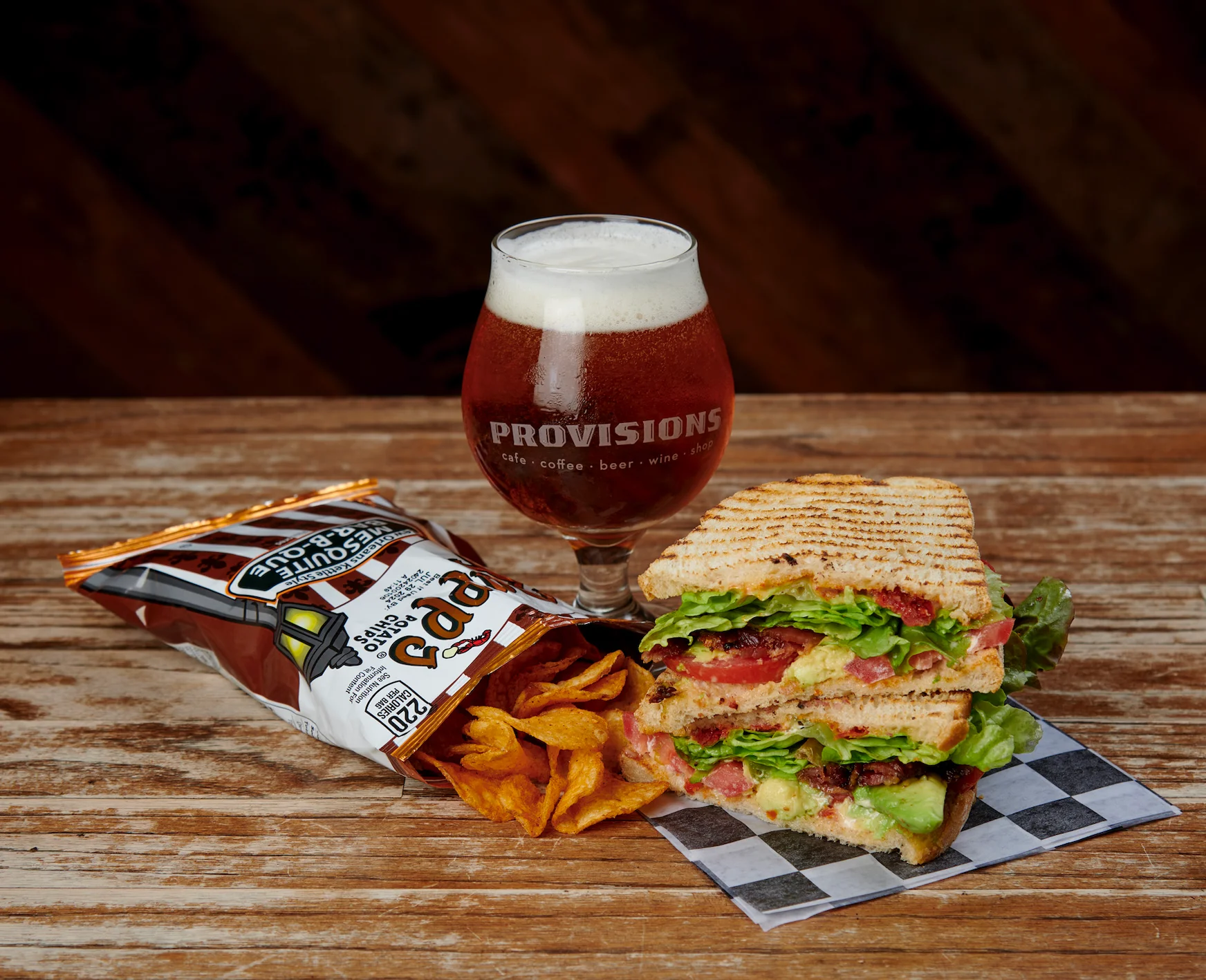 Grilled sandwich with lettuce and tomato served with craft beer