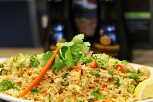 Delicious fried rice garnished with herbs and vegetables