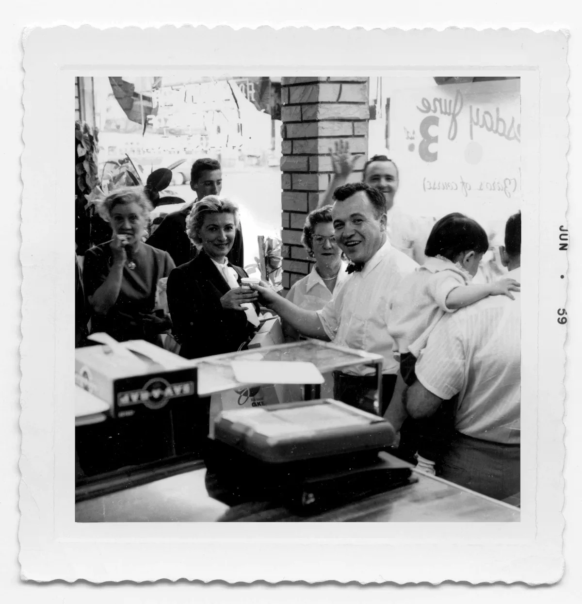 Vintage restaurant scene with smiling patrons and staff