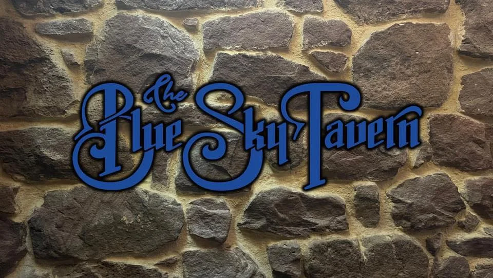 Signage of The Blue Sky Tavern on a stone wall